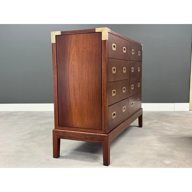 A solid teak campaign style eight drawer dresser with hand cut dovetails and polished brass hardware. Professionally...