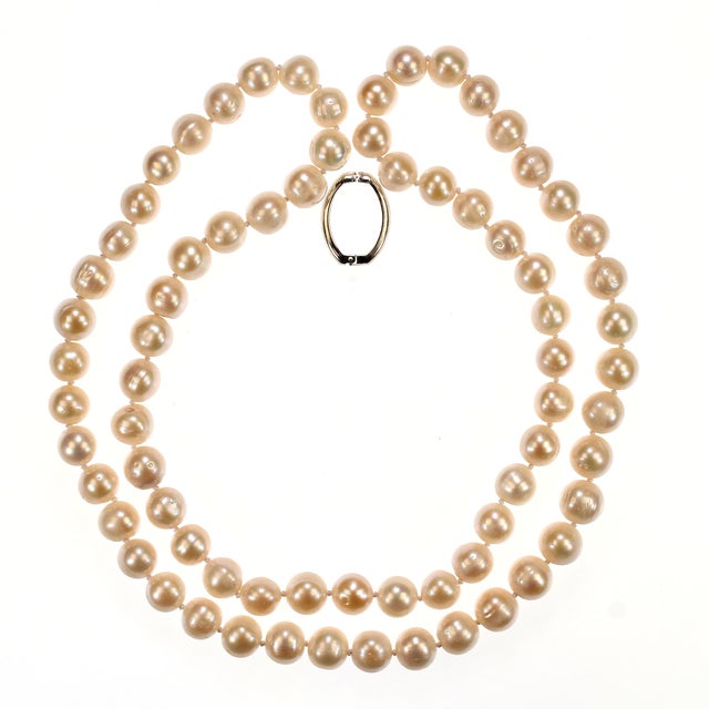 This exquisite 35‑inch freshwater white pearl necklace showcases a strand of luminous 12mm pearls, each one hand‑selected...
