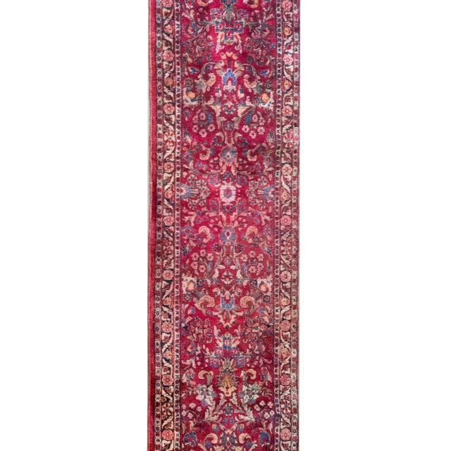 This early 20th-century Persian Sarouk runner is a captivating example of traditional craftsmanship and timeless design....