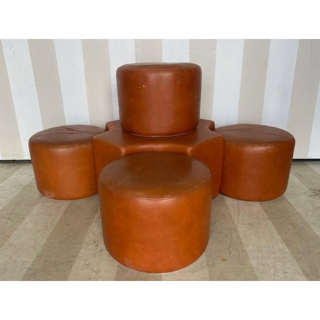Great 5 piece set of leather ottomans attributed by Newel to Pierre Cardin. Each ottoman is approximately 15" in diameter...