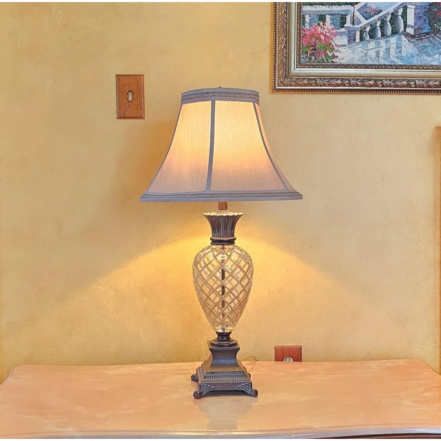 Elegant cut-crystal and bronze pineapple modern table lamp with a custom patented lamp holder and a rounded metal switch....