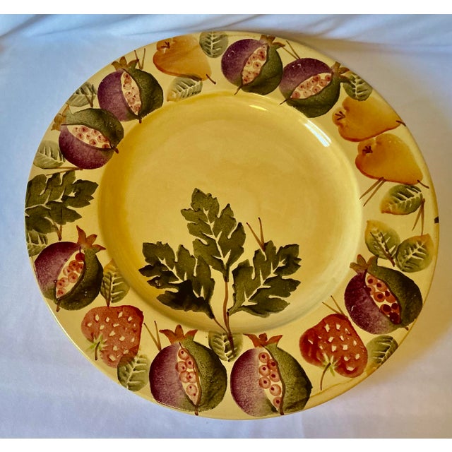 Hand crafted and hand painted serving platter featuring a pattern of pomegranates, strawberries, pears and leaves on a...