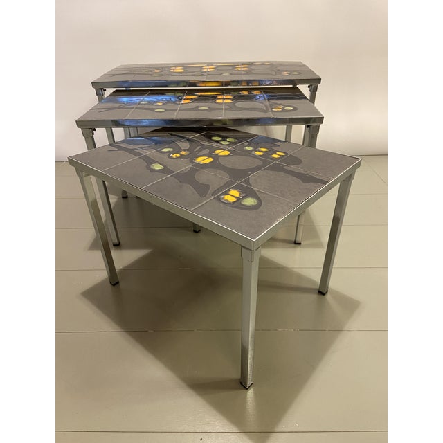 Handcrafted nesting tables by Juliette Belarti, painted ceramic tiles on a chrome frame. I have official proof of...