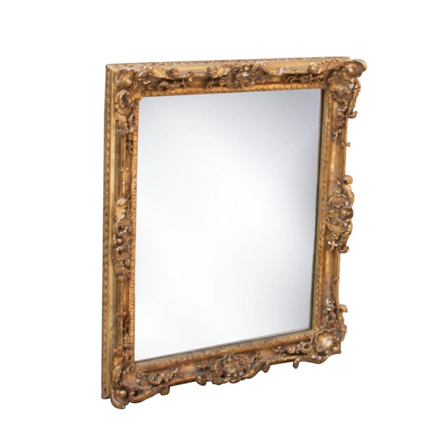Neoclassical Empire style handcrafted mirror. Rectangular hand carved wooden structure with gold foiled finish.