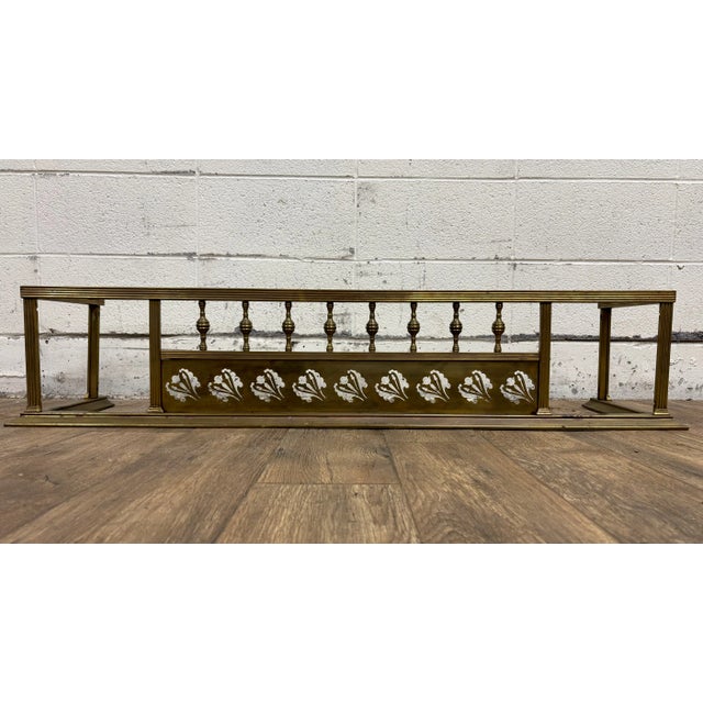 This is a gorgeous antique Victorian traditional brass fireplace fender with pierced metalwork and spindles. In great...