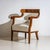 Pair of Biedermeier-style bergères with walnut-veneered frames and armrests ending in stylized volutes. The armchairs have...