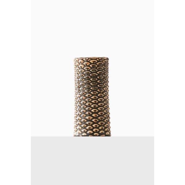 This rare ceramic vase, designed by Axel Salto and produced by Royal Copenhagen in Denmark, is a masterful example of...