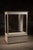 Large freestanding retail display showcase constructed with a painted wood frame, glass front and side panels, glass top,...