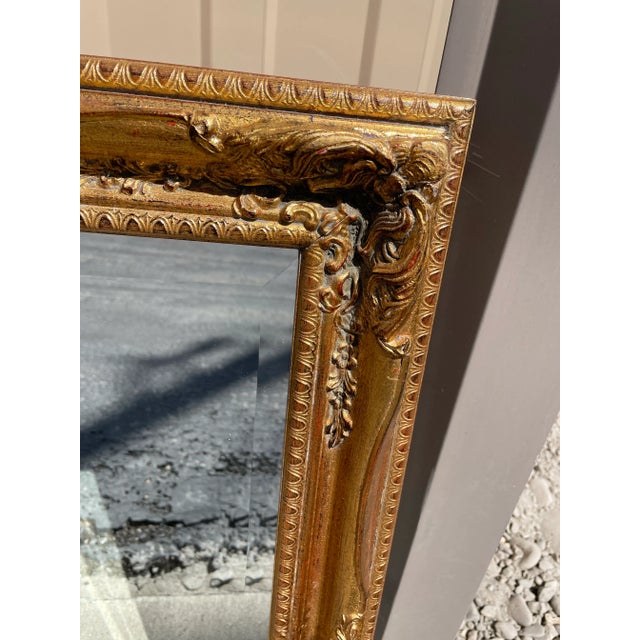Beautiful vintage gold framed beveled mirror. Intricate molding and frame design with gilt accents. Beautiful old world...