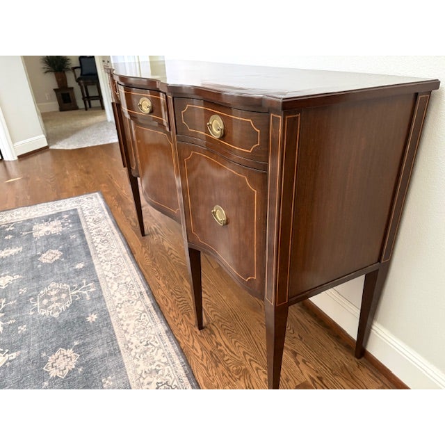 Exceptional rosewood sideboard with black and white wood inlaid facing., entirely lined with silver cloth. Flatware...