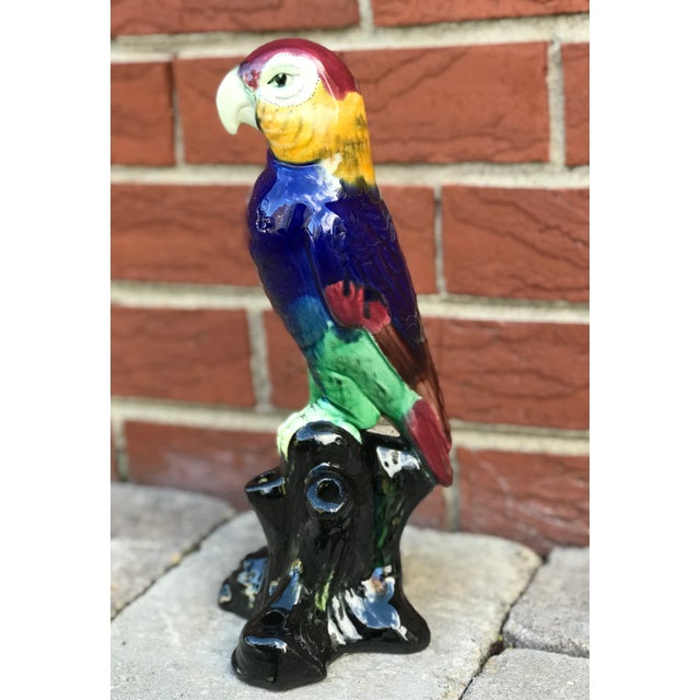 Lovely and colorful with a glossy glaze, this vintage majolica style ceramic parrot looks very dignified atop its perch....