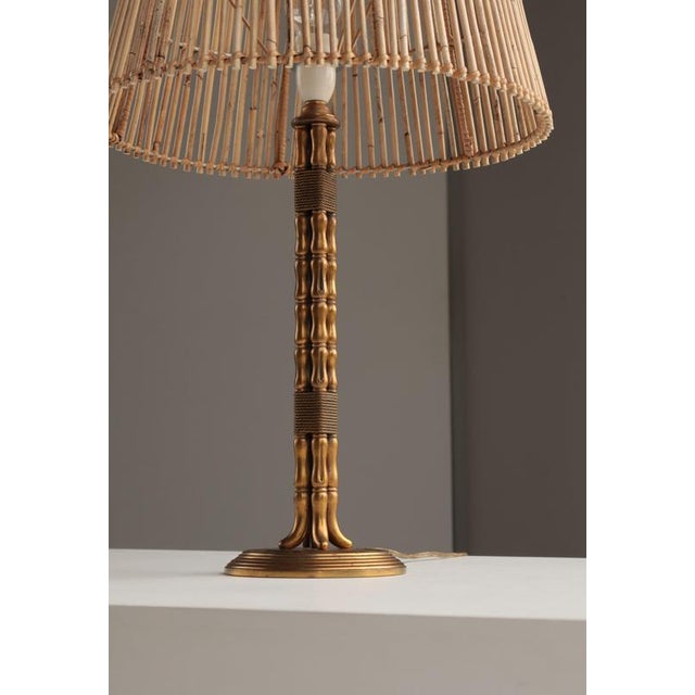 A striking vintage handmade table lamp crafted in solid brass, featuring an intricately turned, bamboo-inspired column...