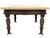An impressive Neoclassical Revival carved wood table featuring a substantial shaped cream marble top and an elaborately...