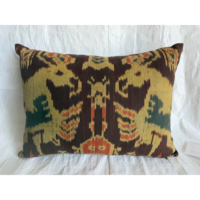 An exceptional antique Central Asian ikat pillow crafted from a rare mid 19th century Uzbek silk and cotton textile...