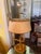 This elegant French Empire-style bouillotte lamp features a classic multi-candle brass design topped with a traditional...