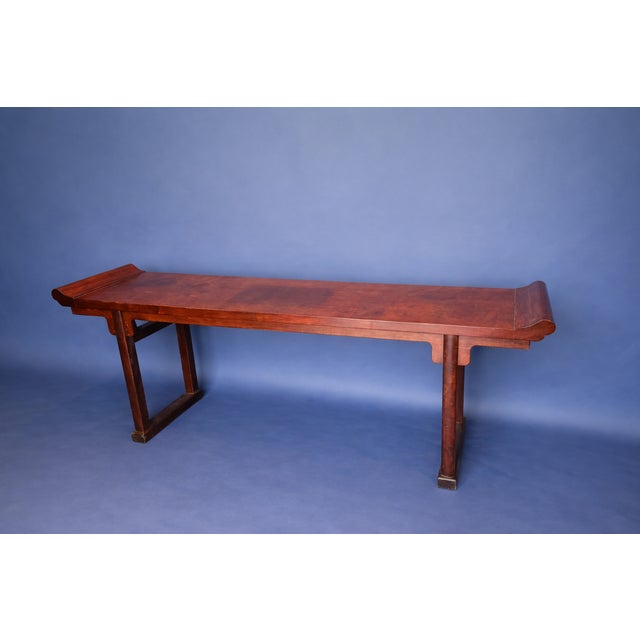 Asian-style wooden altar table with a long, narrow profile & warm finish.
