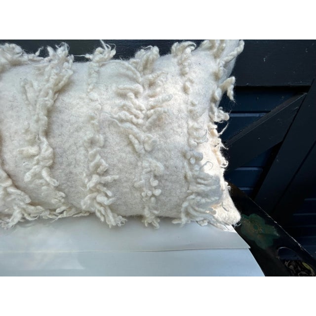 A pillow made from a Japanese boiled wool and felted textile, a down insert is included.