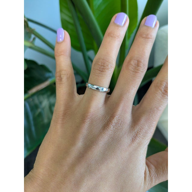 Five earth-mined diamonds sparkle in a clean line across this solid 14K white gold band. Slim and understated, it wears...