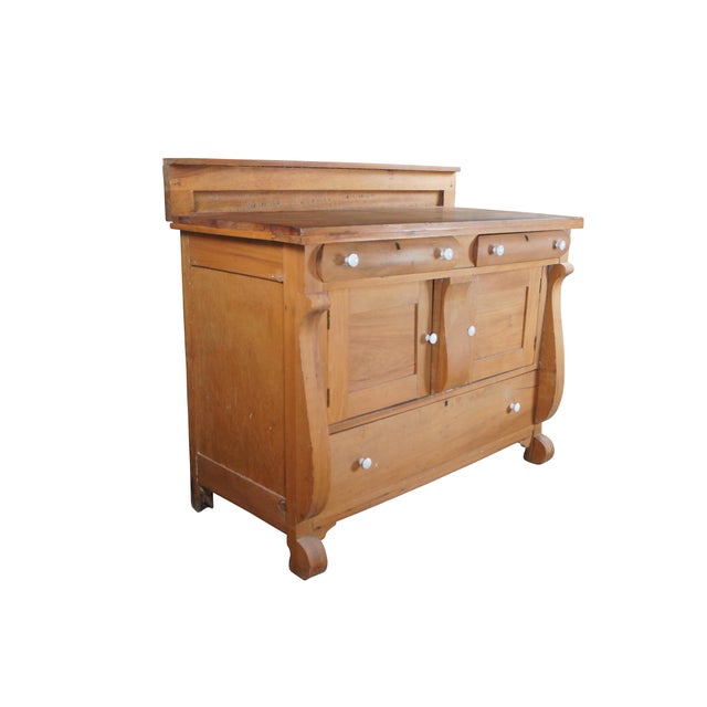 Antique American Empire buffet or sideboard, circa 1900. Features a rectangular form with a short backsplash and two...