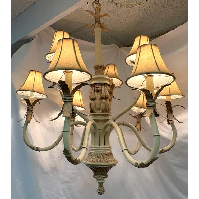 Fun vintage nine light chandelier from the latter 20th century. It has a coastal Chinoiserie style with a leaf and monkey...
