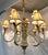 Fun vintage nine light chandelier from the latter 20th century. It has a coastal Chinoiserie style with a leaf and monkey...
