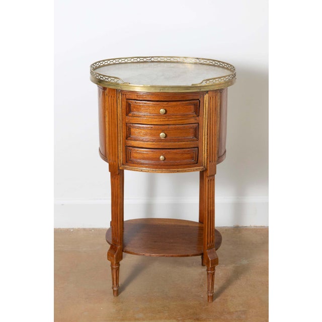 This 18th-century French side table exemplifies the refined elegance and craftsmanship characteristic of Louis XVI...