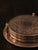 Set of six alpaca coasters with an arabesque pattern on a chromed metal surface. Decorative and functional, they include a...
