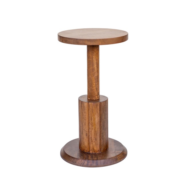 Enhance your space with this sculptural solid wood drink table, featuring clean lines, a geometric base, and a warm...