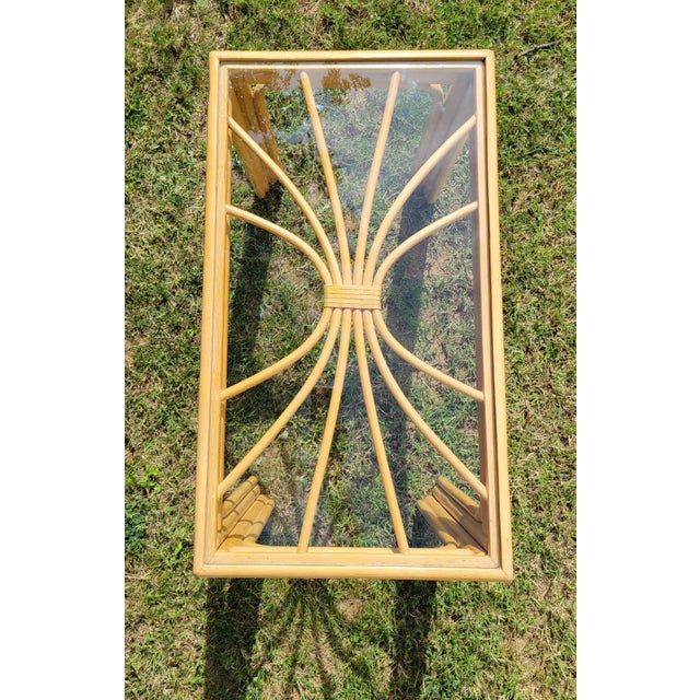 With a smooth, light rattan finish and sunburst pattern, this vintage side table by Vogue Rattan Furniture of Lexington,...