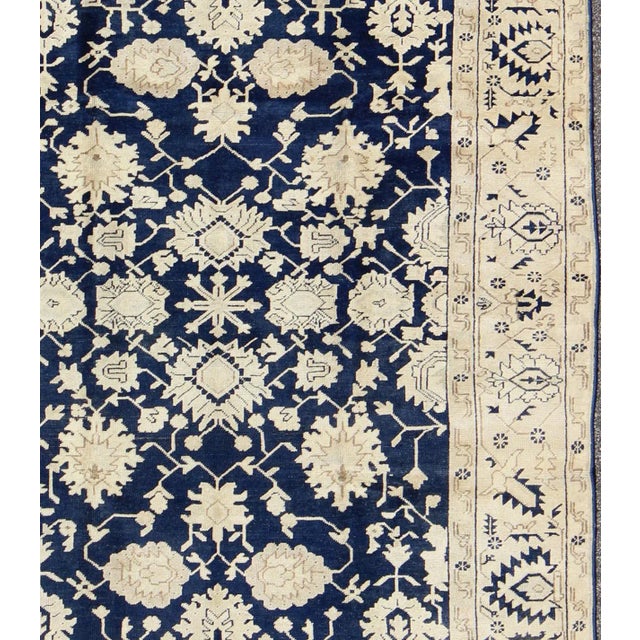 Unique Turkish Oushak Rug with all over Floral Design in Dark Blue, Cream and Light Brown rug/ This unique Oushak rug...