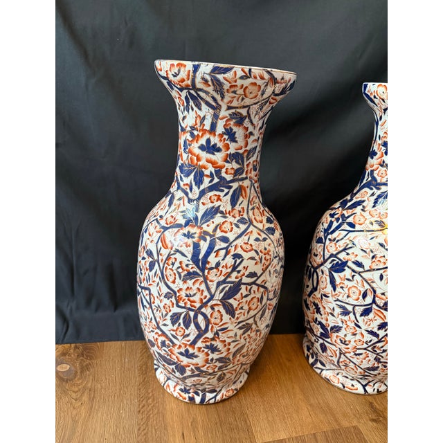 Striking pair of large vintage Japanese Imari porcelain floor vases, each standing an impressive 22 inches tall. Hand-...