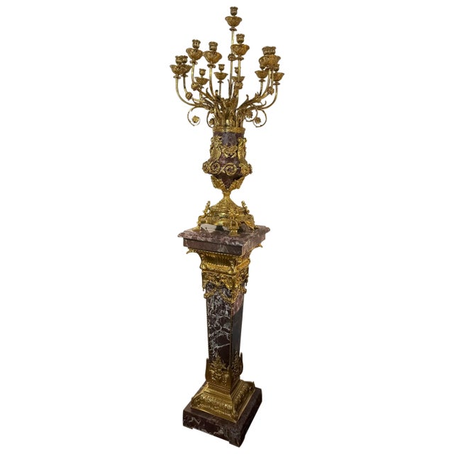 Listed is a gorgeous Louis XV French style marble pedestal with large brass accents. Resting on top is a magnificent solid...
