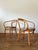 A set of four original Thonet bentwood dining chairs, circa mid-20th century, featuring the iconic curved beechwood frames...