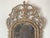 An exceptional 18th century Italian Rococo mirror, exquisitely hand-carved in wood and retaining its original parcel-gilt...