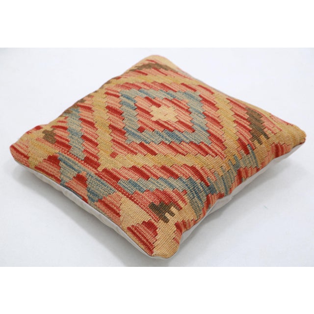 A one-of-a-kind handwoven Afghan wool kilim accent pillow featuring stepped diamond medallion. Cut and sewn by hand from a...