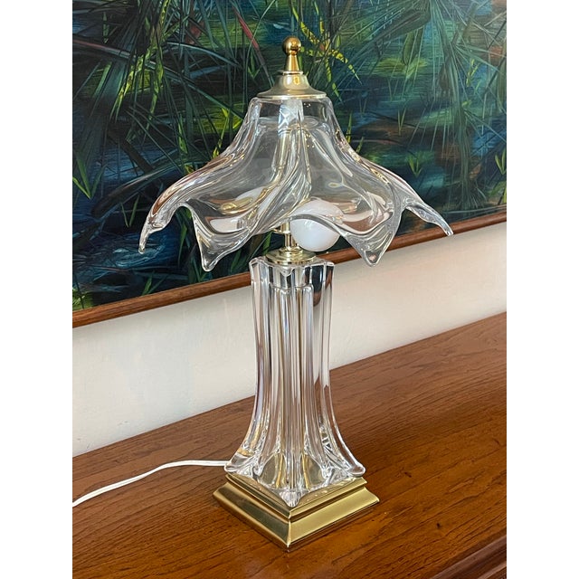 Striking Hollywood Regency style table lamp featuring a sculptural clear crystal base and dramatic draped art glass shade....