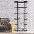 The Brooklyn Etagere features a towering iron frame in a graphite finish with subtle gold accents and clear glass...