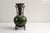 This striking artisan‑made glazed ceramic vase features a rich blend of deep green, earthy brown, and warm amber tones,...