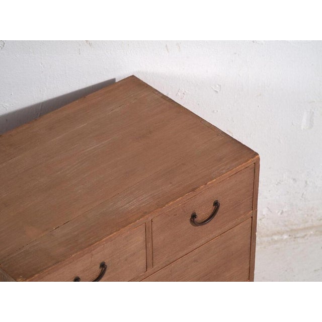 Small antique Japanese chest of drawers crafted in paulownia wood (kiri), dating to the Showa period, circa 1950–1970....