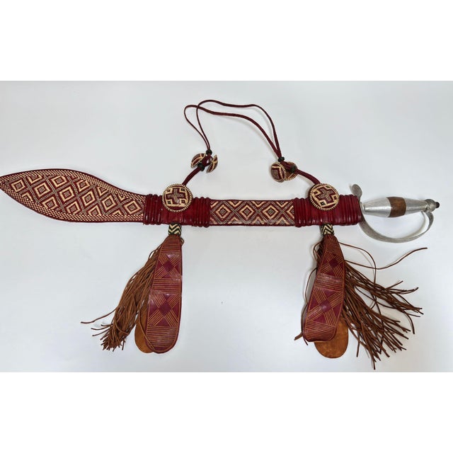 Mandinka Ceremonial Sword with Decorated Leather Scabbard, West Africa, circa 1950 A striking and highly collectible...
