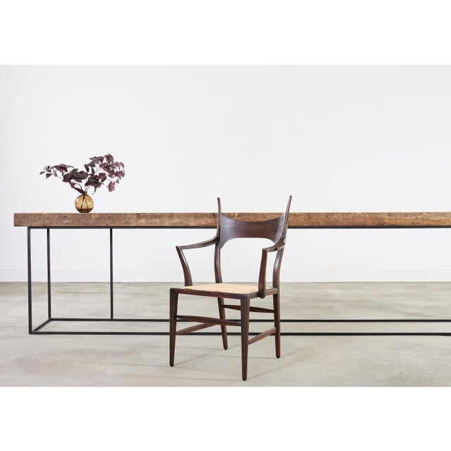 A striking and architectural console table composed around a single monolithic reclaimed timber top made on a monumental...