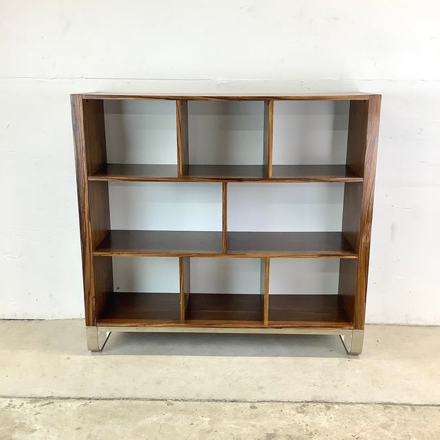 A striking piece of contemporary shelving with a graphic zebrawood veneer that commands attention. The asymmetric layout —...