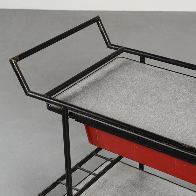 Trolley at two levels with a square tubular structure in black lacquered metal. with bottle compartments on the bottom...