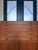 Authentic Danish modern modular wall unit cabinet set (2) featuring rich teak veneers, sculptural recessed pulls, and...