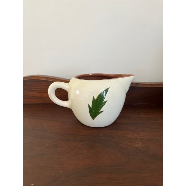 A beautiful example of classic American pottery, this vintage Stangl Thistle creamer features the beloved botanical...