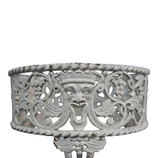 An antique Oscar Bach attributed painted bronze figural plant stand, dating to approximately 1920. This piece showcases...