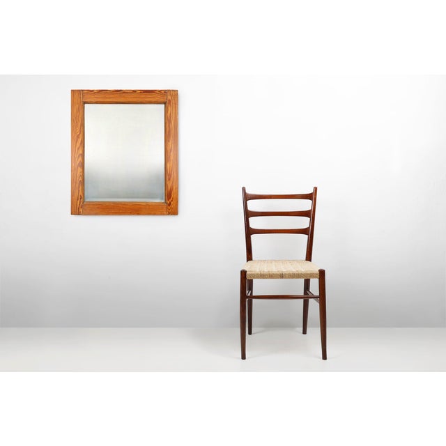 This antique mirror from France, circa 1900, embodies the quiet elegance of early 20th‑century craftsmanship. Its warm...
