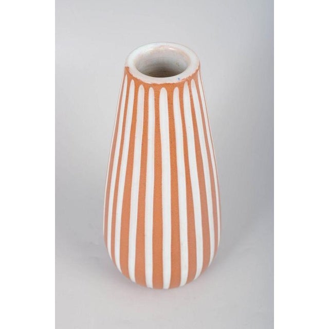 Ingrid Atterberg for Upsala-Ekeby, vase. Slim baluster-shaped vase in glazed ceramic with vertical white stripes on a...