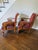 A striking pair of traditional upholstered accent chairs by Powell, featuring richly patterned burgundy tapestry...