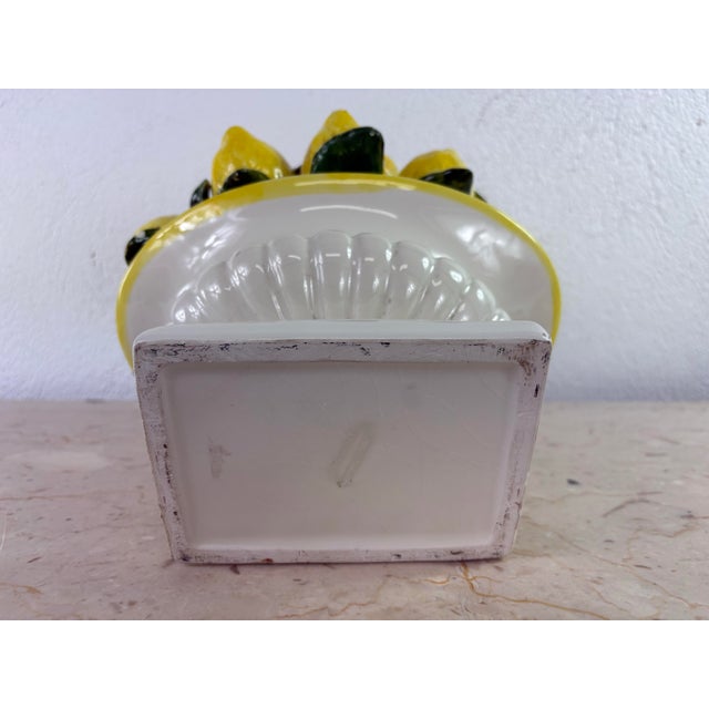 This is a large vibrant pottery lemon topiary. This decorative pottery bowl of lemons has a white classical urn base with...